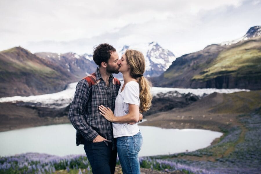 a millennial couple kiss in front of a glacier in iceland t20 goyVOk