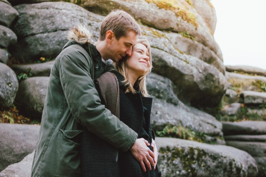 happy young pregnant family dressed in casual style walking together on nature park in the cold t20 gRxzOd