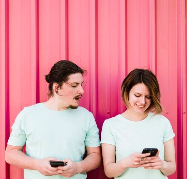 young man spying peeking smartphone her girlfriend using mobile phone 23 2148179668